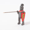 Black wooden toy knight with green dragon on red shield | © Conscious Craft